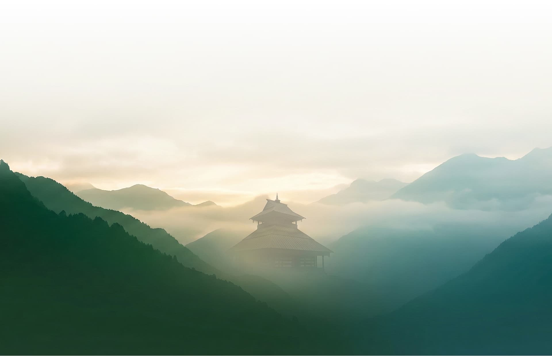 Traditional wooden pagoda temple amid misty Himalayan mountains