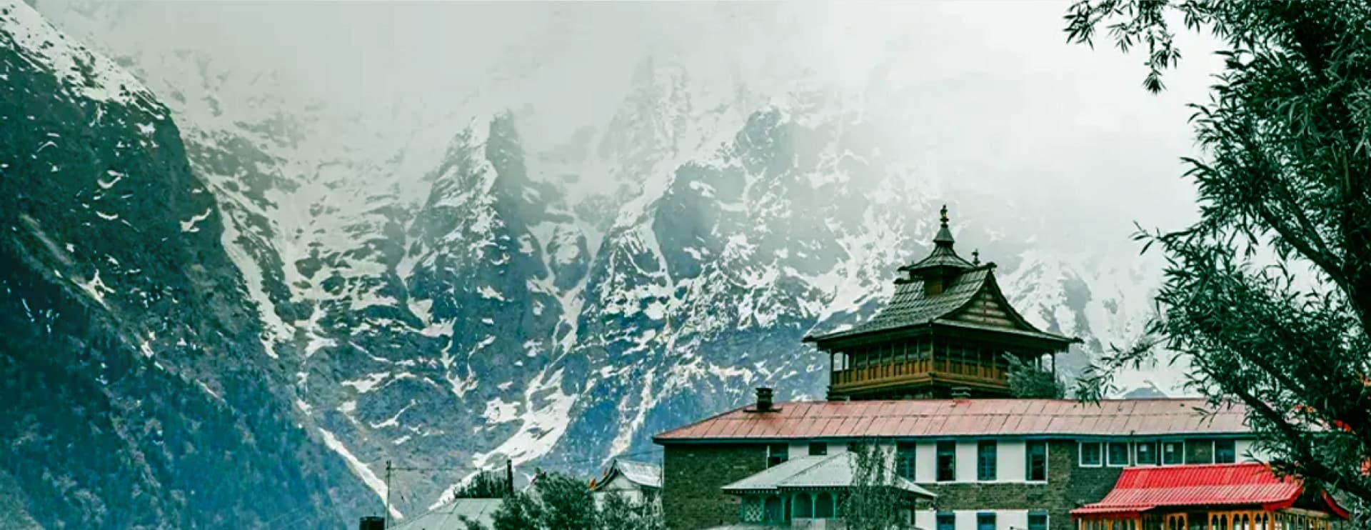 Himachal Pradesh mountain village beneath snow-capped peaks